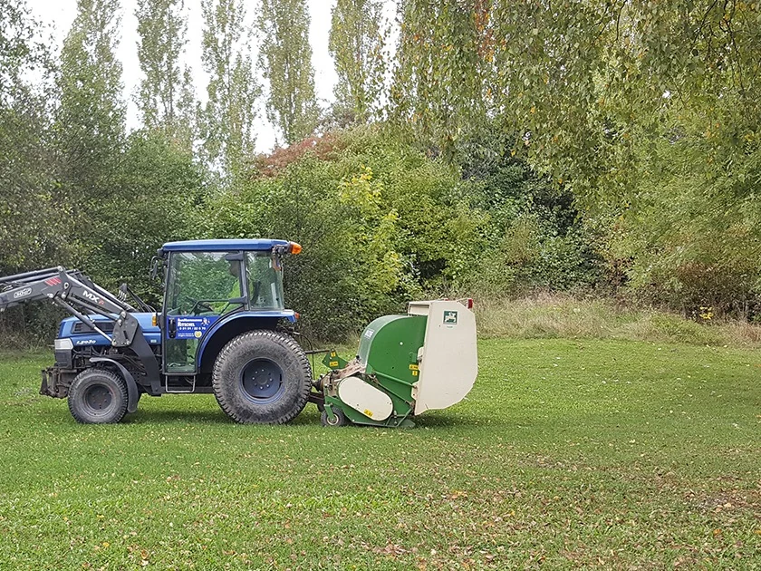 Traktor mit Mähwerk auf einer Grünanlage